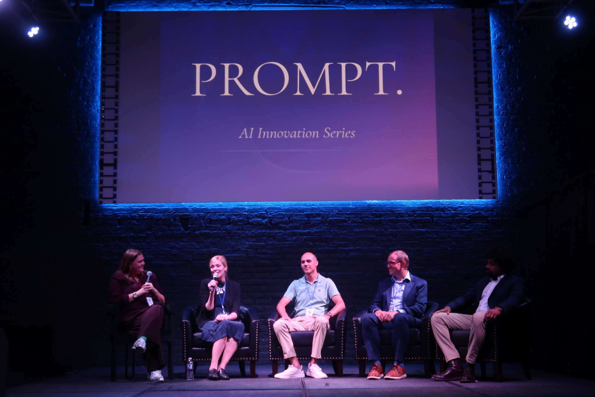 Panel of experts speaking on stage during the PROMPT AI Innovation Series